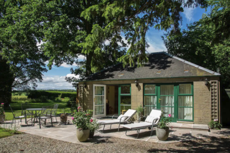 The Doocot: single storey detached garden building set under trees