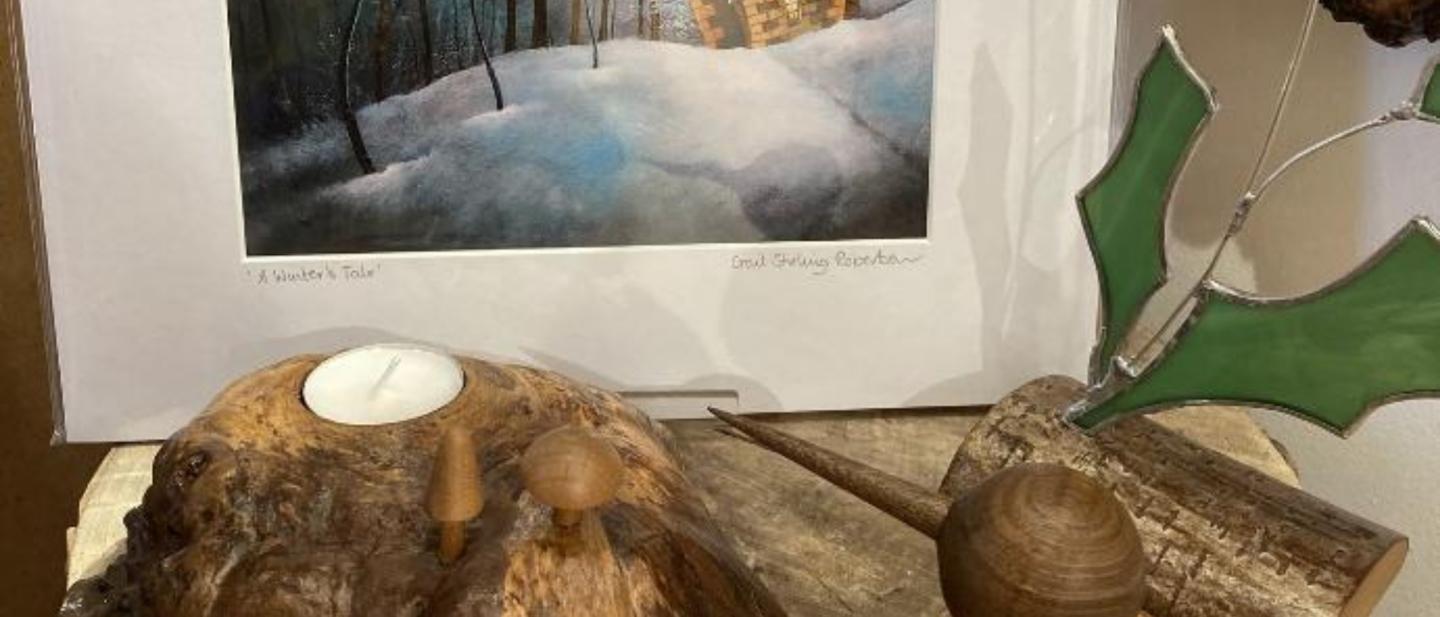 Local crafted goods, including a print, a candle holder, a Christmas ornament and a wooden bird © Lorna Radbourne